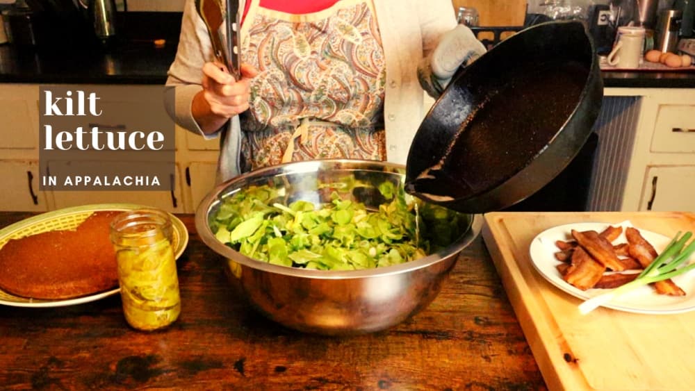 woman pouring grease on lettuce