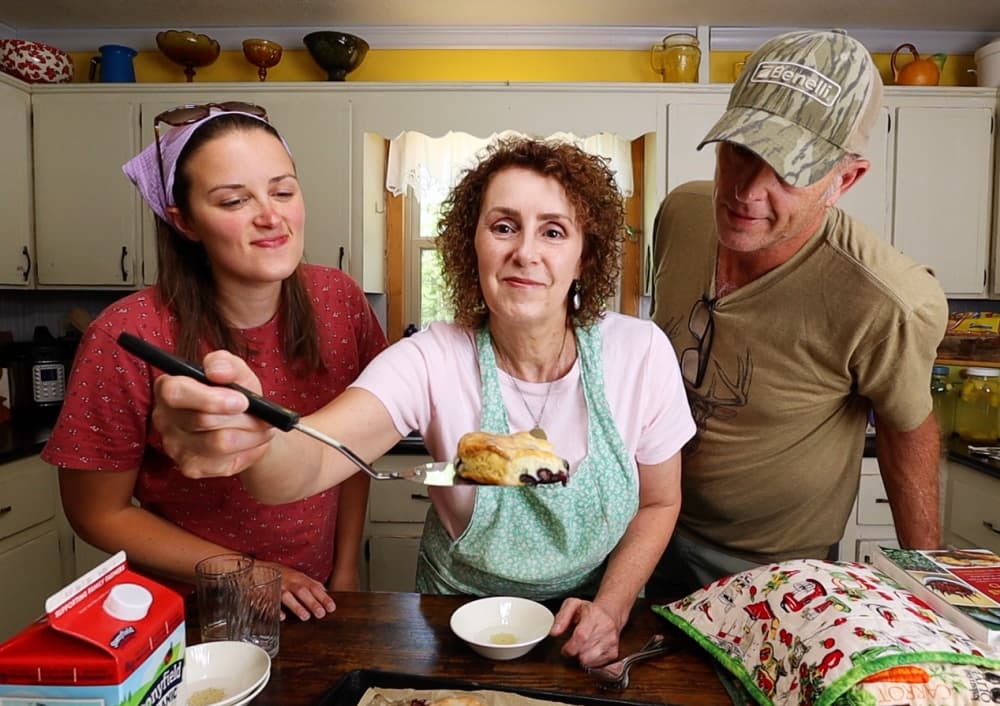 man woman and girl with just baked biscuit