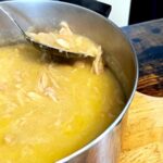spoon in pot of chicken and dumplings