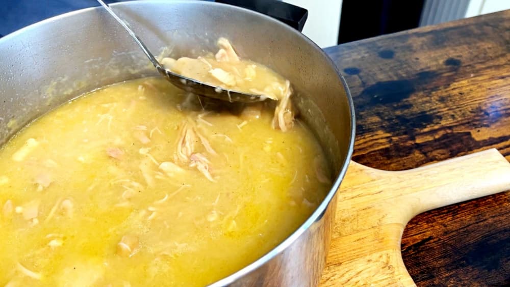 spoon in pot of chicken and dumplings