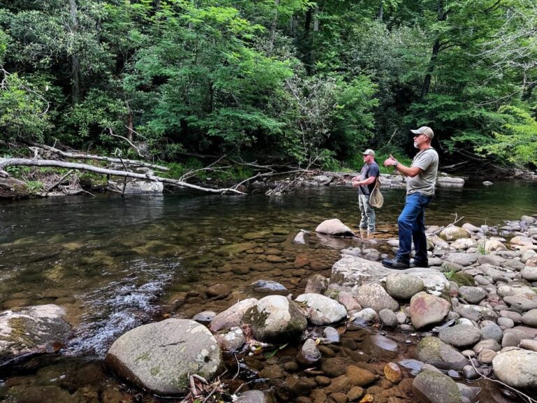 men fishing in creek