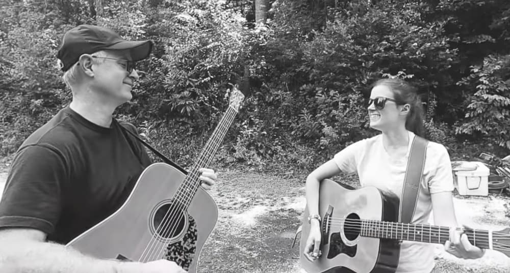 man and woman with guitars