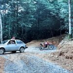 gray car motorcycle and man