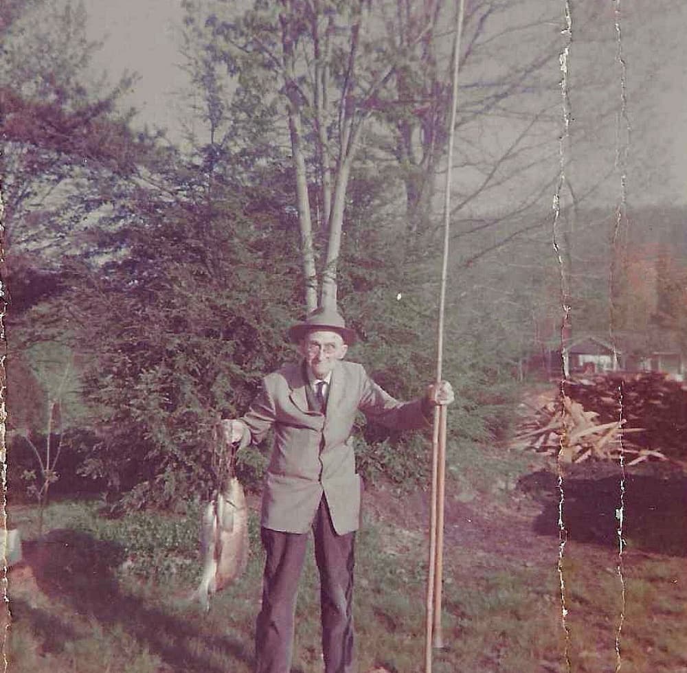 old man holding stringer of fish