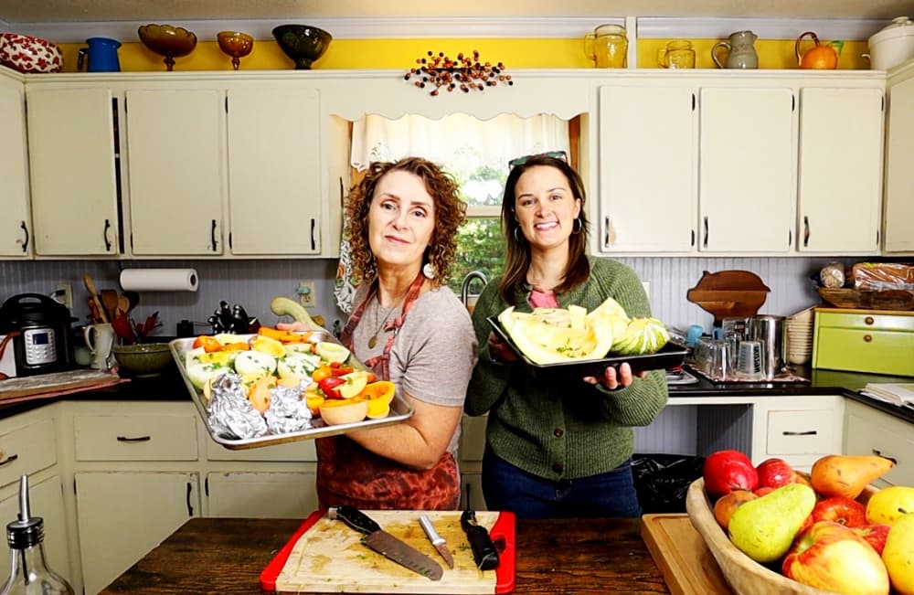 women holding trays of vegetables